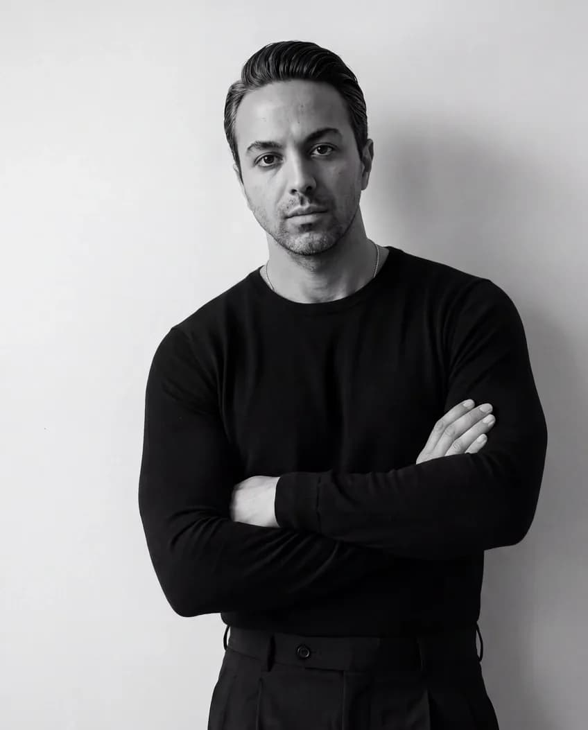 Ehsan Sorkhkhah in a black sweater with arms crossed